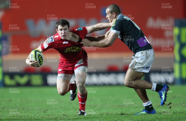 28.01.12 - Scarlets v London Irish, LV= Cup -  Scarlets Adam Warren is held by London Irish's Jonathan Joseph  