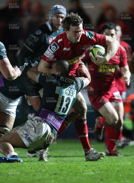 28.01.12 - Scarlets v London Irish, LV= Cup -  Scarlets Andy Fenby is held by London Irish's Jonathan Joseph  