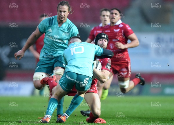 020319 - Scarlets v Munster - Guinness PRO14 - Leigh Halfpenny of Scarlets is tackled by Bill Johnston of Munster