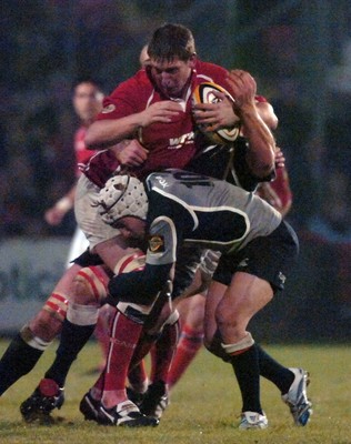 05.11.06 - Llanelli Scarlets v Munster - Magners League - Scarlets Adam Jones is tackled by Munster's Jeremy Manning 