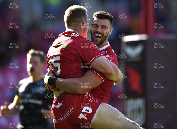101021 - Scarlets v Munster - United Rugby Championship - Johnny McNicholl of Scarlets celebrates scoring try with Johnny Williams