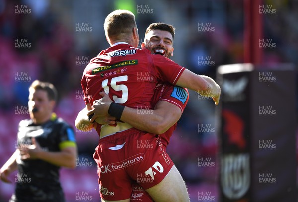 101021 - Scarlets v Munster - United Rugby Championship - Johnny McNicholl of Scarlets celebrates scoring try with Johnny Williams