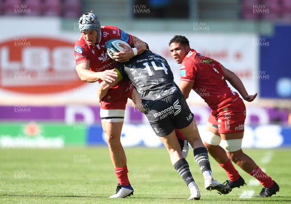 101021 - Scarlets v Munster - United Rugby Championship - Jonathan Davies of Scarlets is tackled by Calvin Nash of Munster