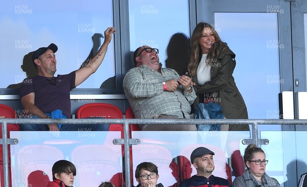 101021 - Scarlets v Munster - United Rugby Championship - Carol Vorderman watches the game with former rugby player Rupert Moon (cap) and singer and actor Wynne Evans