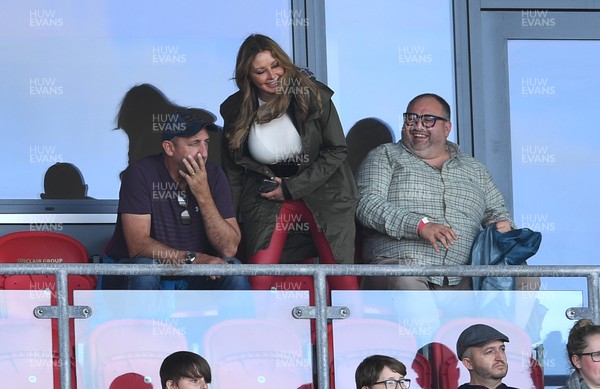 101021 - Scarlets v Munster - United Rugby Championship - Carol Vorderman watches the game with former rugby player Rupert Moon (cap) and singer and actor Wynne Evans