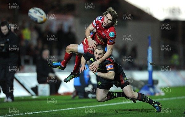 160213 - Scarlets v Munster - RaboDirect PRO12 -Liam Williams of Scarlets is tackled by Johne Murphy of Munster