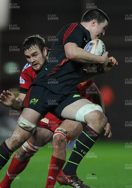 160213 - Scarlets v Munster - RaboDirect PRO12 -Ian Nagle of Munster is tackled by Joe Snyman of Scarlets