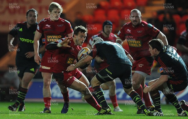 160213 - Scarlets v Munster - RaboDirect PRO12 -Andy Fenby of Scarlets takes on Duncan Williams of Munster