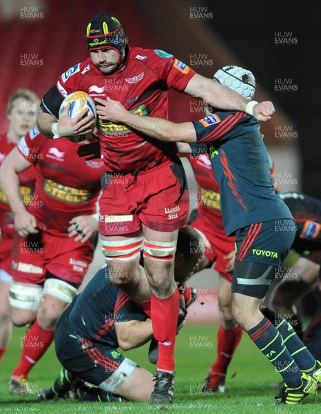 160213 - Scarlets v Munster - RaboDirect PRO12 -George Earl of Scarlets is tackled by BJ Botha of Munster and Duncan Williams of Munster