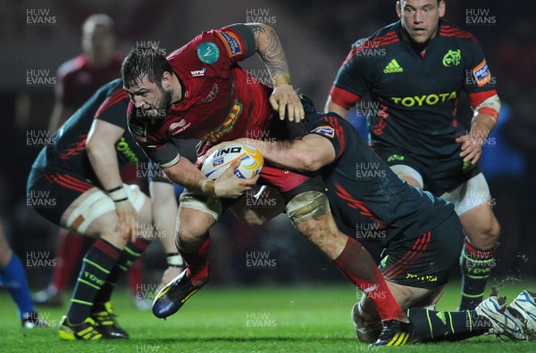 160213 - Scarlets v Munster - RaboDirect PRO12 -Josh Turnbull of Scarlets is tackled by Tommy O'Donnell of Munster