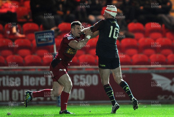 160213 - Scarlets v Munster - RaboDirect PRO12 -Gareth Davies of Scarlets and Ronan O'Gara of Munster exchange blows