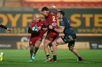 160224 - Scarlets v Munster - United Rugby Championship - Ioan Nicholas of Scarlets is challenged by Tom Ahern of Munster 