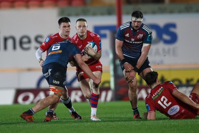 160224 - Scarlets v Munster - United Rugby Championship - Johnny McNicholl of Scarlets is tackled by Ruadhan Quinn of Munster