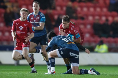 160224 - Scarlets v Munster - United Rugby Championship - Jarrod Taylor of Scarlets takes on Joey Carbery of Munster