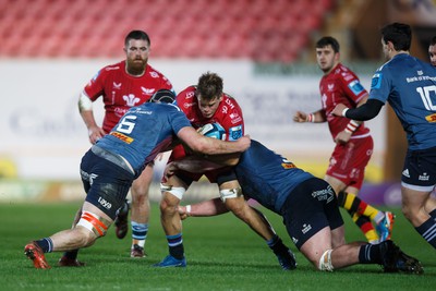 160224 - Scarlets v Munster - United Rugby Championship - Jarrod Taylor of Scarlets is tackled by Ruadhan Quinn of Munster