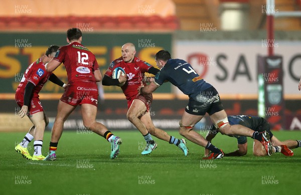 160224 - Scarlets v Munster - United Rugby Championship - Ioan Nicholas of Scarlets is challenged by Tom Ahern of Munster 
