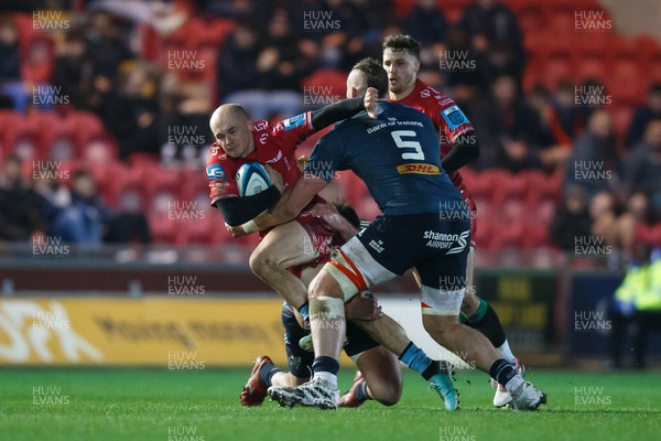 160224 - Scarlets v Munster - United Rugby Championship - Ioan Nicholas of Scarlets takes on RG Snyman of Munster