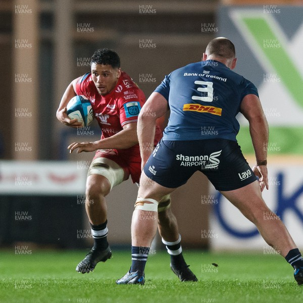 160224 - Scarlets v Munster - United Rugby Championship - Dan Davis of Scarlets takes on Oli Jager of Munster