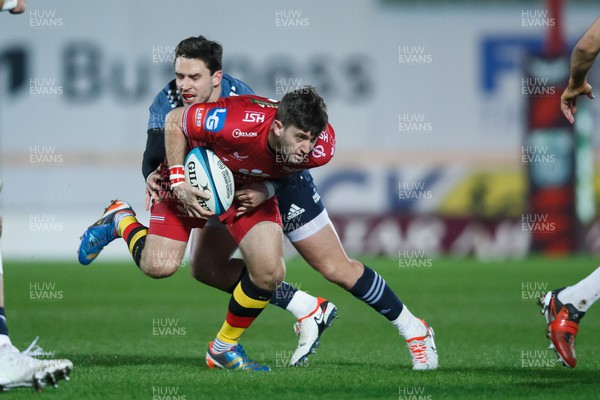 160224 - Scarlets v Munster - United Rugby Championship - Dan Jones of Scarlets is tackled by Joey Carbery of Munster