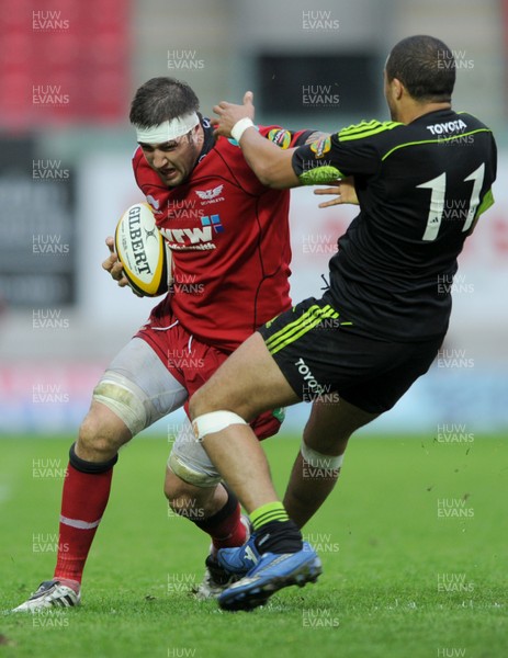 16.04.11 - Scarlets v Munster - Magners League - Josh Turnbull of Scarlets is tackled by Simon Zebo of Munster. 