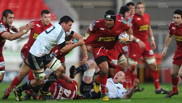 210412 - Scarlets v Munster - RaboDirect PRO12 -Deacon Manu of Scarlets takes on Ian Keatley of Munster