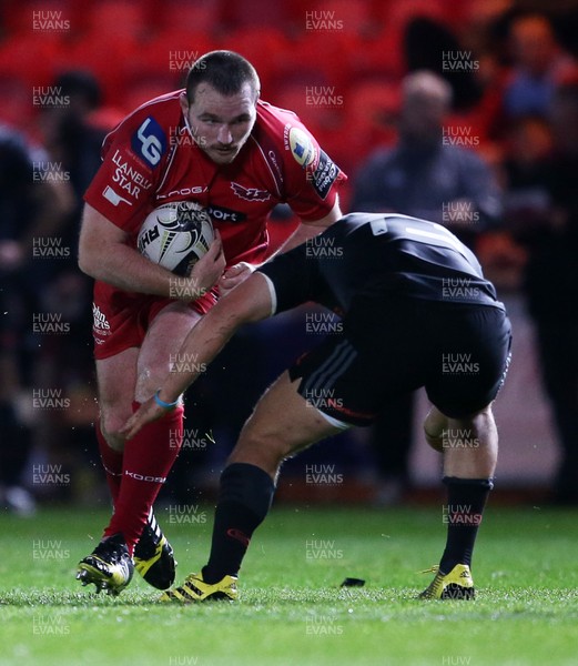 231015 - Scarlets v Munster - Guinness PRO12 - Ken Owens of Scarlets takes on David Johnston of Munster