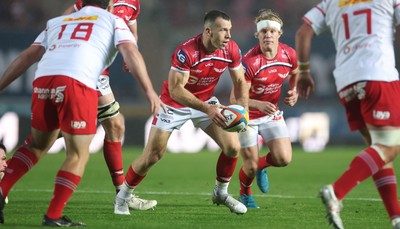 270925 - Scarlets v Munster, United Rugby Championship - Gareth Davies of Scarlets chips through to set up try for Ellis Mee of Scarlets