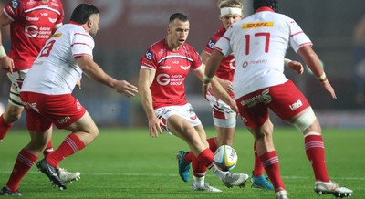 270925 - Scarlets v Munster, United Rugby Championship - Gareth Davies of Scarlets chips through to set up try for Ellis Mee of Scarlets