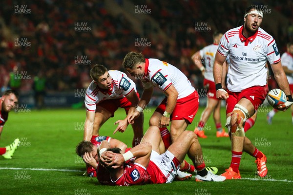 270925 - Scarlets v Munster - United Rugby Championship - Jack Crowley of Munster calls for assistance for Sam Costelow of Scarlets after he was injured in a tackle