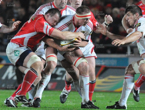 28.11.08 - Magners League Rugby -  Llanelli Scarlets v Munster Munster's Mick O'Driscoll is tackled by Scarlets' Nathan Thomas 