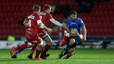 081016 - Scarlets v Newport Gwent Dragons - Guinness PRO12 - Adam Warren of Newport Gwent Dragons is tackled by Hadleigh Parkes of Scarlets