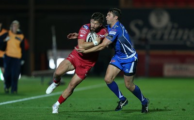 081016 - Scarlets v Newport Gwent Dragons - Guinness PRO12 - DTH van der Merwe of Scarlets is tackled by Charlie Davies of Newport Gwent Dragons