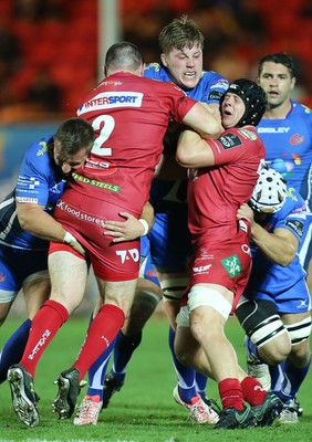 081016 - Scarlets v Newport Gwent Dragons, Guinness PRO12 - Matthew Screech of Newport Gwent Dragons is stopped by Ken Owens of Scarlets and James Davies of Scarlets