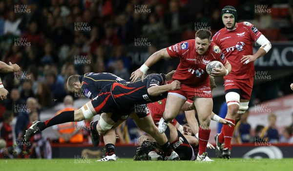 150417 - Newport Gwent Dragons v Scarlets - Guinness PRO12 - Rob Evans of Scarlets is tackled by Lewis Evans of Newport Gwent Dragons