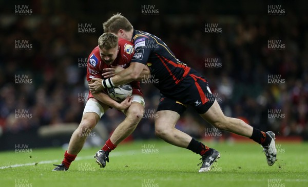 150417 - Newport Gwent Dragons v Scarlets - Guinness PRO12 - James Davies of Scarlets is tackled by Tyler Morgan of Newport Gwent Dragons