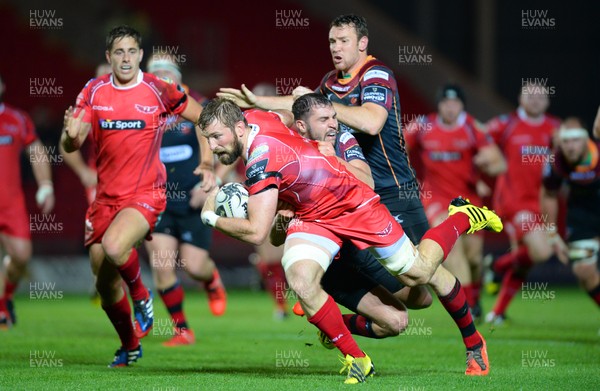 301015 - Scarlets v Newport Gwent Dragons - Guinness PRO12 -John Barclay of Scarlets is tackled by Charlie Davies of Newport Gwent Dragons