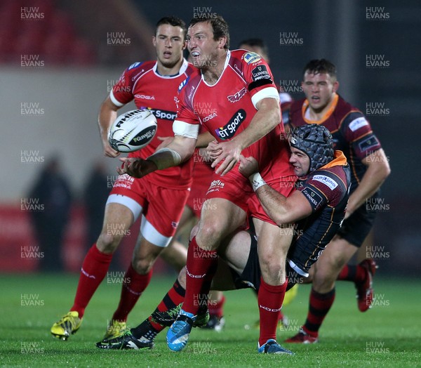 301015 - Scarlets v Newport Gwent Dragons - Guinness PRO12 - Hadleigh Parkes of Scarlets is tackled by Adam Hughes of Newport Gwent Dragons