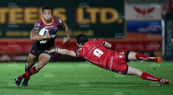 301015 - Scarlets v Newport Gwent Dragons - Guinness PRO12 - Ashton Hewitt of Newport Gwent Dragons goes past Rhodri Williams of Scarlets