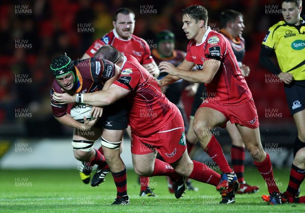 301015 - Scarlets v Newport Gwent Dragons - Guinness PRO12 - Nic Cudd of Newport Gwent Dragons is tackled by Peter Edwards of Scarlets