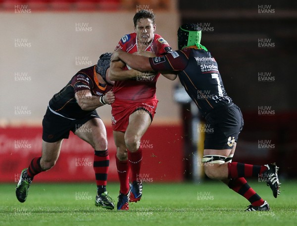 301015 - Scarlets v Newport Gwent Dragons - Guinness PRO12 - Aled Thomas of Scarlets is tackled by Adam Hughes and Nic Cudd of Newport Gwent Dragons