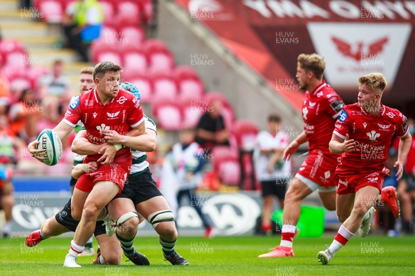040921 - Scarlets v Nottingham - Preseason Friendly - Steff Evans of Scarlets offloads the ball in the tackle