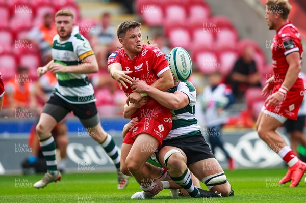 040921 - Scarlets v Nottingham - Preseason Friendly - Steff Evans of Scarlets offloads the ball in the tackle