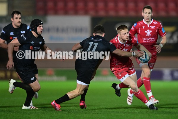 010122 - Scarlets v Ospreys - United Rugby Championship - Johnny McNicholl of the Scarlets under pressure from Luke Morgan of the Ospreys   