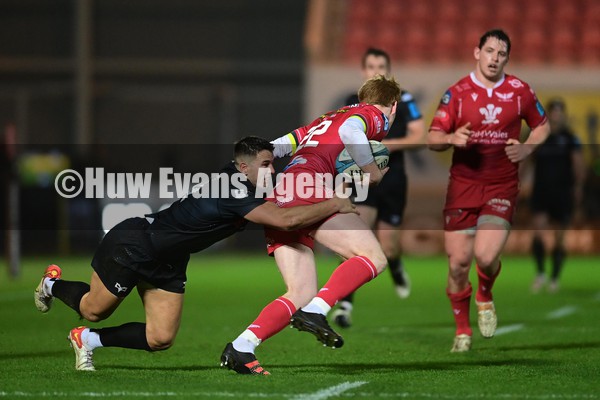 010122 - Scarlets v Ospreys - United Rugby Championship - Rhys Patchell of the Scarlets evades the tackle of Owen Watkin of the Ospreys  