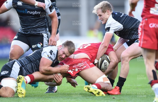 061018 - Scarlets v Ospreys - Guinness PRO14 - Josh Macleod of Scarlets is tackled by Olly Cracknell and Aled Davies of Ospreys