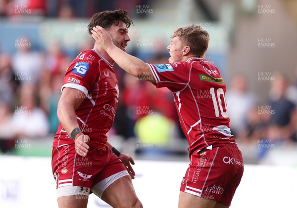 170922 - Scarlets v Ospreys, United Rugby Championship - Sam Costelow of Scarlets celebrates with Johnny Williams of Scarlets after he races in to score try