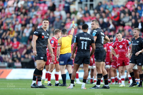 170922 - Scarlets v Ospreys - United Rugby Championship - Referee Adam Jones shows a yellow card to Sam Costelow of Scarlets