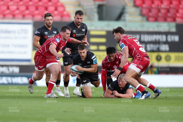 170922 - Scarlets v Ospreys - United Rugby Championship - Joe Hawkins of Ospreys is tackled by Ryan Elias and Johnny Williams of Scarlets