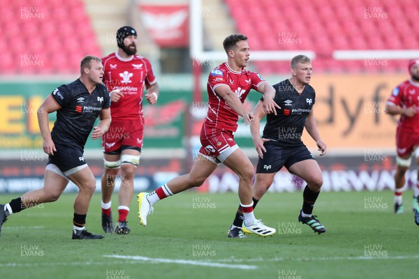 170922 - Scarlets v Ospreys - United Rugby Championship - Kieran Hardy of Scarlets spreads the ball to his backs