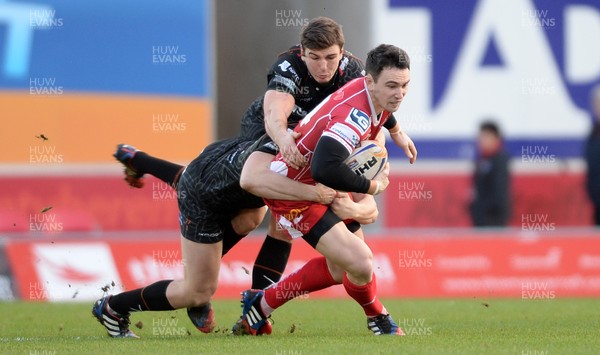 261213 - Scarlets v Ospreys - RaboDirect PRO12 -Kristian Phillips of Scarlets is tackled by Ben John and Sam Lewis of Ospreys